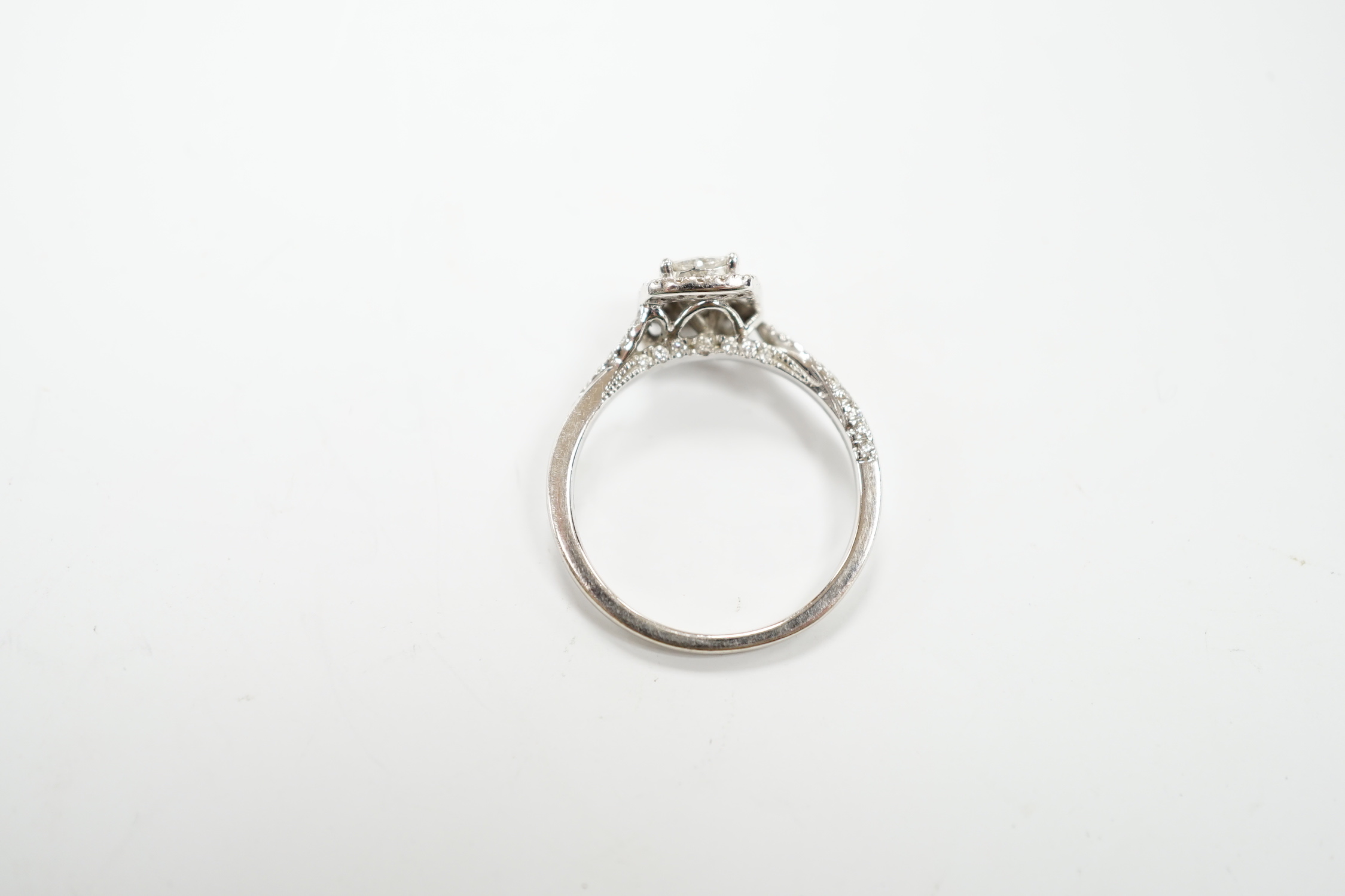 A modern 14ct white gold and diamond set cluster ring, size M/N, gross weight 2.7 grams.